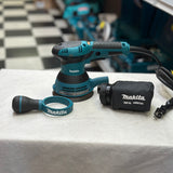 Five-inch hook-and-loop sanding pad on Makita BO5041 random orbit sander