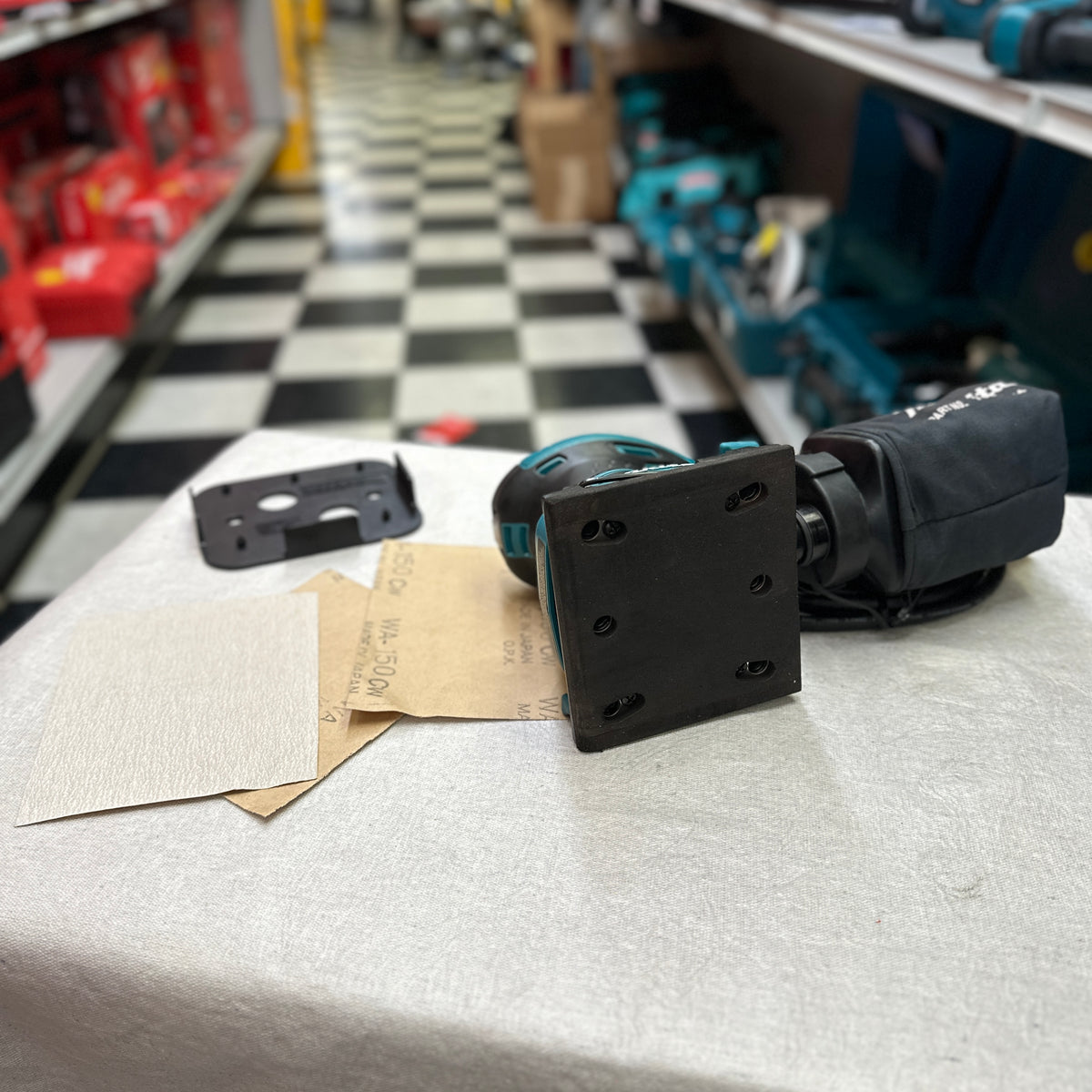 Punch plate and sanding sheets included with Makita BO4556 sander