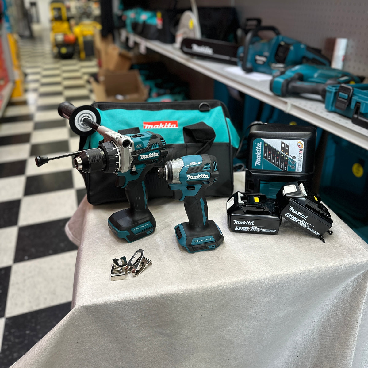 Makita cordless drill driver front view with side handle and depth rod