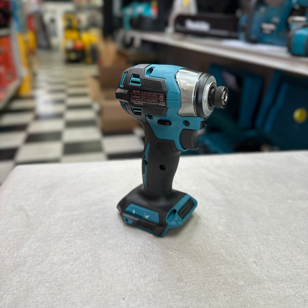 Two Makita 18V 5.0Ah batteries beside charger and carrying bag
