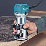Makita compact router held to show lightweight ergonomic design